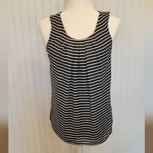 Elle size small black with white stripes on the front and a button in back